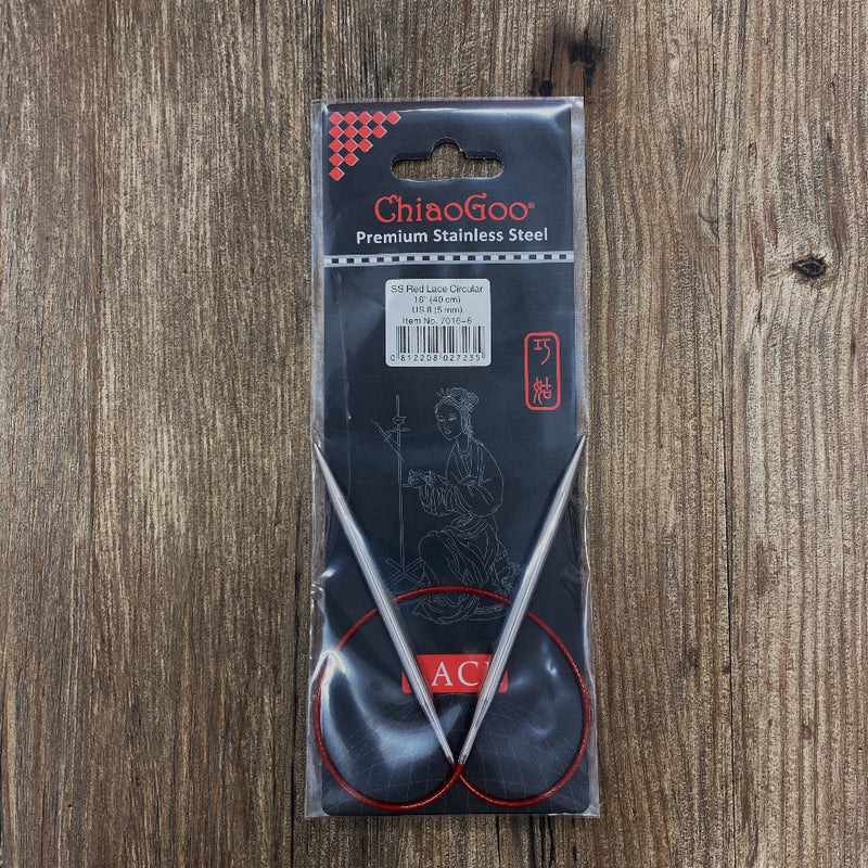 ChiaoGoo knitting needle set in clear packaging on a wooden surface