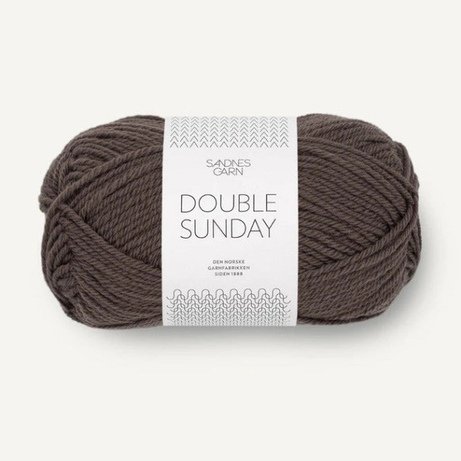 Ball of brown yarn with a label on a white background