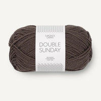 Ball of brown yarn with a label on a white background