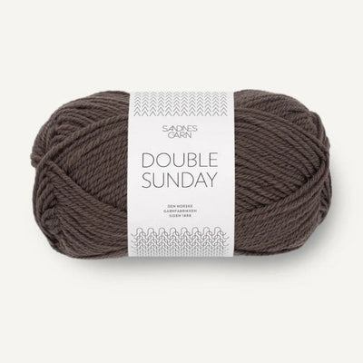 Ball of brown yarn with a label on a white background