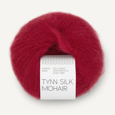 Red ball of yarn with a label on a white background