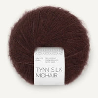 Ball of dark brown Tynn Silk Mohair yarn with a label on a white background