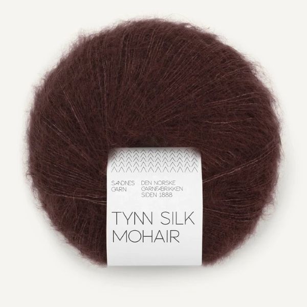 Ball of dark brown Tynn Silk Mohair yarn with a label on a white background