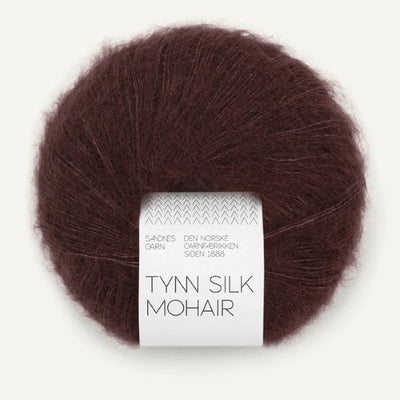 Ball of dark brown Tynn Silk Mohair yarn with a label on a white background