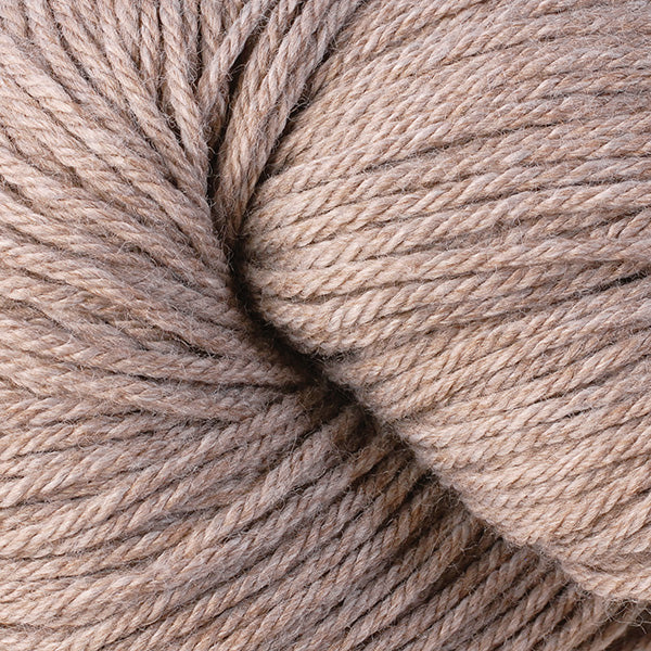 Close-up of a ball of light brown, heathered yarn