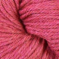 Close-up of a ball of coral-pink yarn