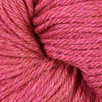 Close-up of a ball of coral-pink yarn