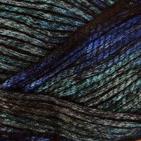 A close-up of dark yarn with a shimmering, iridescent finish that reflects blue, aqua, and green tones.