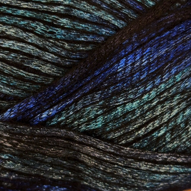 A close-up of dark yarn with a shimmering, iridescent finish that reflects blue, aqua, and green tones.