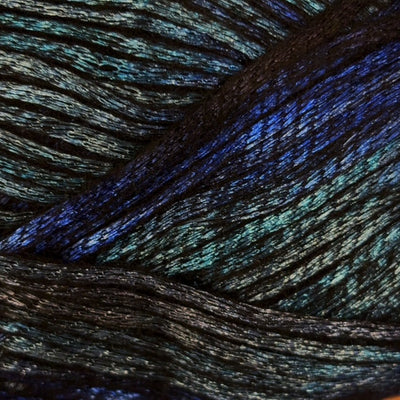 A close-up of dark yarn with a shimmering, iridescent finish that reflects blue, aqua, and green tones.