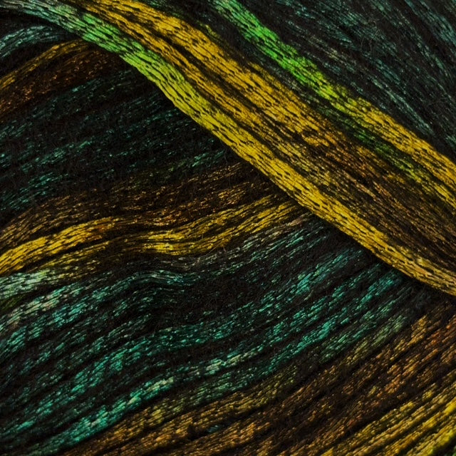 Close-up of variegated yarn strands in a dark base with shimmering olive, green, and yellow metallic highlights.