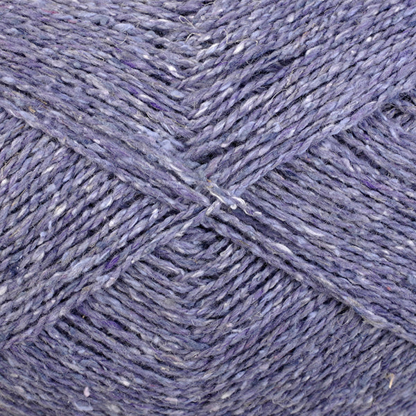 Close-up of pale purple yarn with a tweedy texture