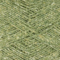 Close-up of green yarn with a tweedy textured surface