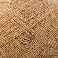 Close-up of a ball of pale yellow tweedy yarn