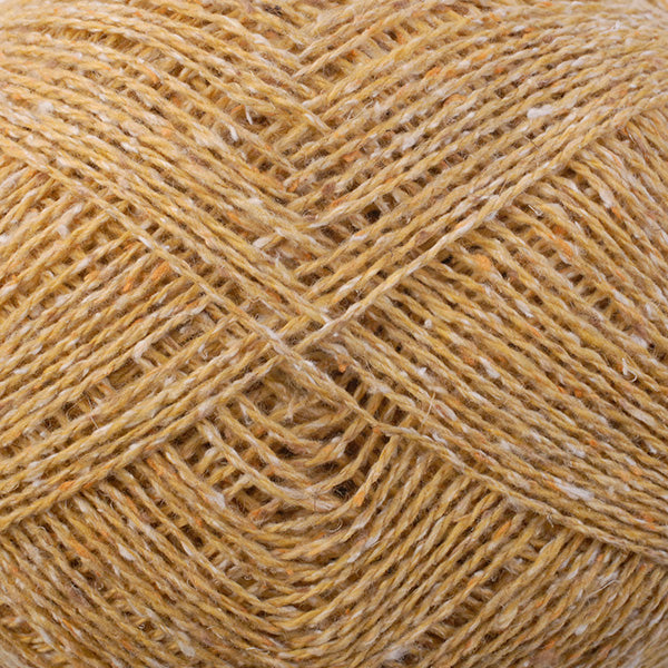 Close-up of a ball of pale yellow tweedy yarn