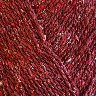 Close-up of red yarn with a textured tweed surface