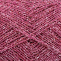 Close-up of pink yarn with a textured tweed surface