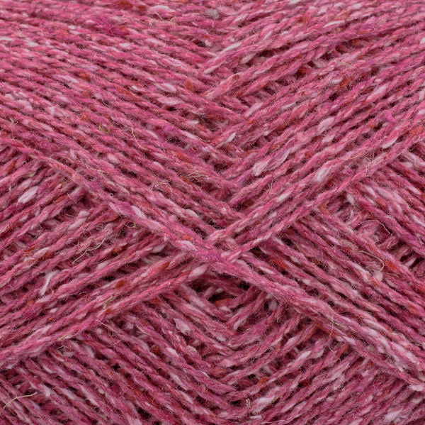 Close-up of pink yarn with a textured tweed surface