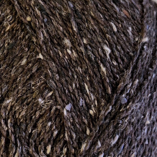 Close-up of a textured brown yarn with light tweed neps