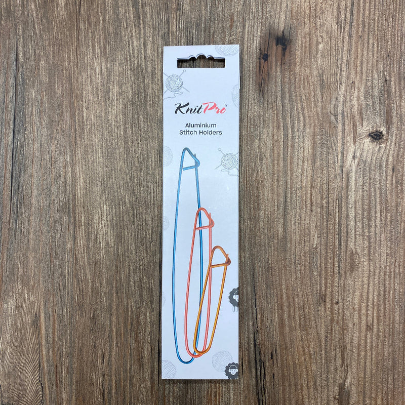 KnitPro aluminum stitch holder packaging on a wooden surface