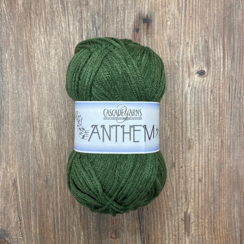 Green skein of yarn with a label on a wooden background