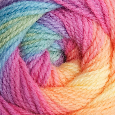 Close-up of colorful yarn with a gradient from blue to pink to orange.