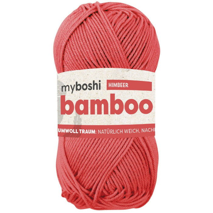 Coral skein of yarn with a label on a white background
