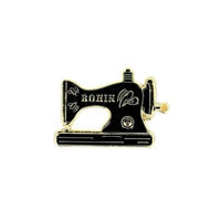 Needle minder with a black vintage sewing machine design on a white background