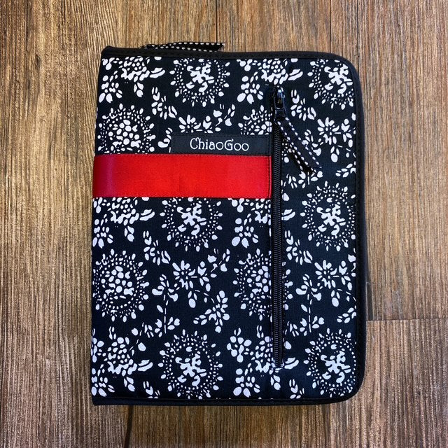 Floral-patterned pouch with a red strip and 'ChiaoGoo' branding on a wooden surface