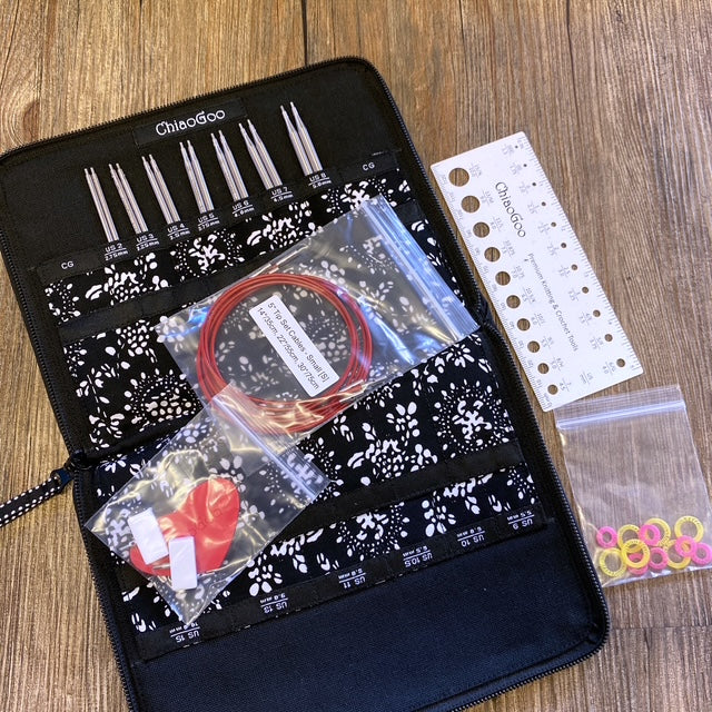 Knitting needle set with case on a wooden surface