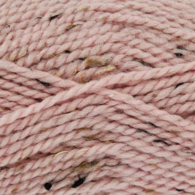 Close-up of pale pink yarn with black and brown specks