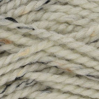 Close-up of cream yarn with brown and black specks