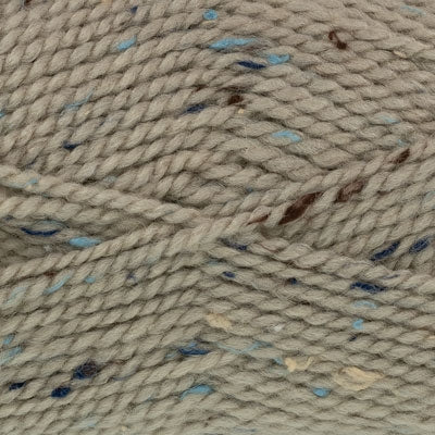Close-up of beige yarn with blue and brown specks