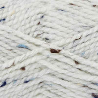 Close-up of white yarn with blue and brown specks