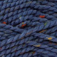 Close-up of blue yarn with green, orange, and yellow specks