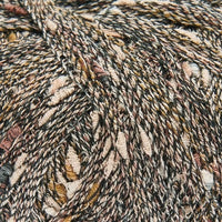 Close-up of textured yarn with brown, beige, and black colors.