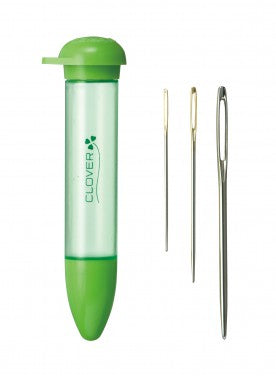 A Clover brand needle kit featuring a translucent light green plastic tube with a bright green cap and base, alongside three metal sewing needles of varying sizes, all set against a plain white background.