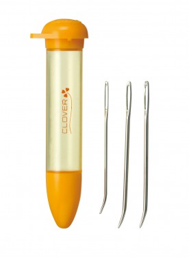 An orange and clear plastic needle tube with a screw-top lid, shown next to three metal bent-tip wool needles on a plain white background. The tube features the Clover brand logo.