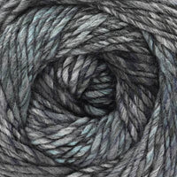 Close-up of a ball of black, gray, and pale blue variegated yarn.