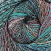 Close-up of a ball of multicolored yarn with shades of blue, green, purple, and brown.