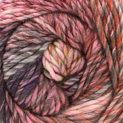 Close-up of a skein of multicolored yarn with pinks, brown, and purple tones.
