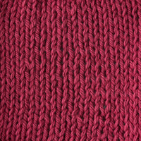 Close-up of a textured light red knit fabric 