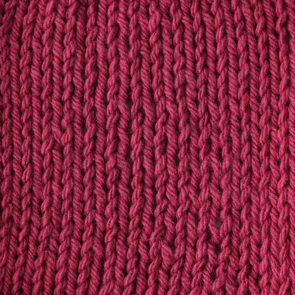 Close-up of a textured light red knit fabric 