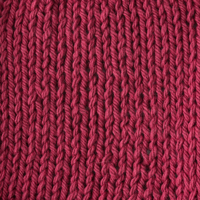Close-up of a textured light red knit fabric 
