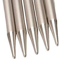 Close-up of metallic needles on a white background