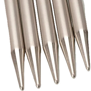 Close-up of metallic needles on a white background
