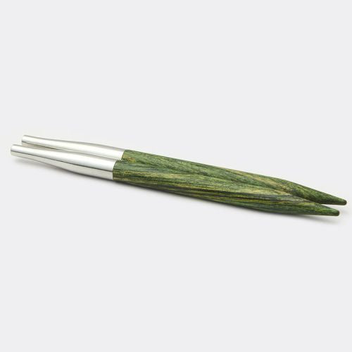 Set of green wooden and silver metal knitting needles on a white background