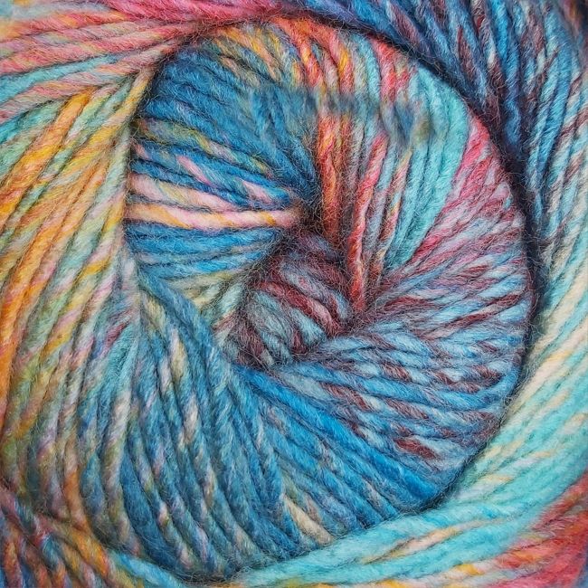 Close-up of a skein of multicolored yarn with blue, green, orance, burgundy, and pink hues.