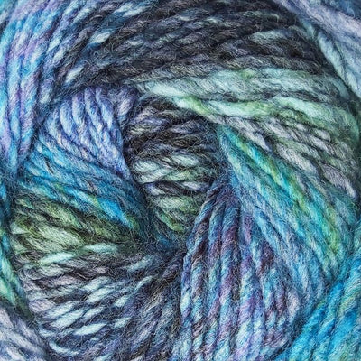 Close-up of a skein of multicolored yarn with shades of blue, navy, green, and purple.