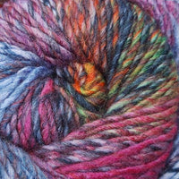 Close-up of a skein of multicolored yarn with shades of pink, blue, orange, purple,  and green.